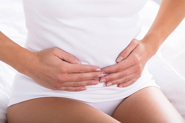 alimentos que prendem e soltam o intestino mulher com a mão no intestino